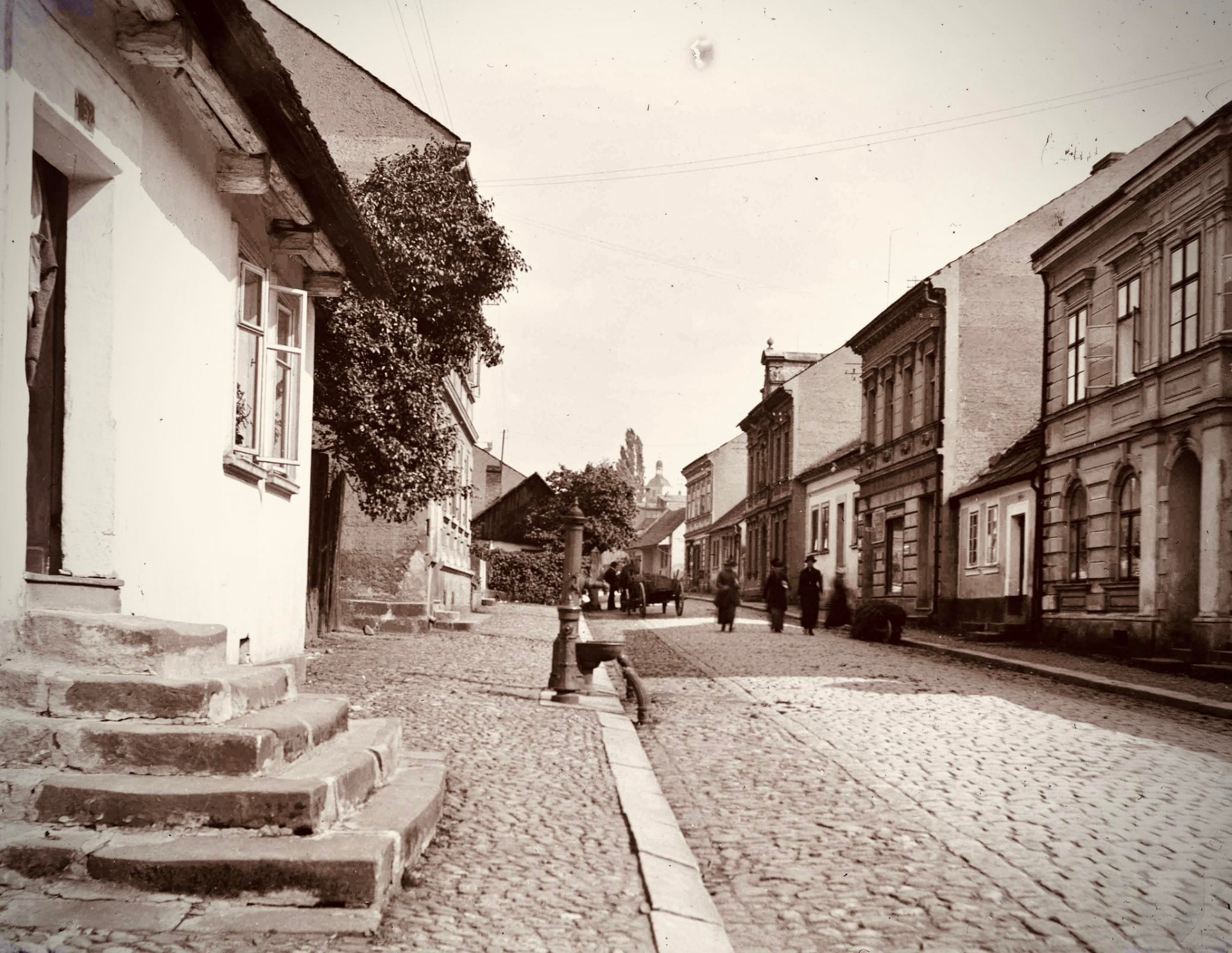 Turnov. Ulice 5. května (dříve Riegrova ulice). Vlevo dům čp. 57 – dle majitelů nazýván Beranův, s výrazným schodištěm před vstupem. Před domem pumpa a hydrant. 20. léta 20. století. Zdroj: Muzeum Českého ráje v Turnově