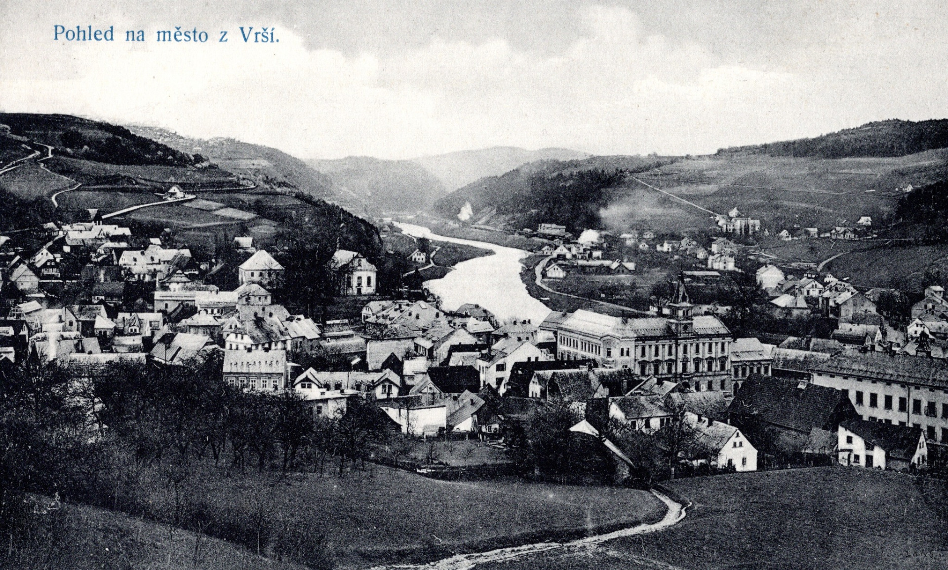 Železný Brod. Ta budova s věžičkou je radnice (městský úřad) úplně vpravo ten dlouhý dům sklářská škola. Vpravo nahoře cesta do Semil, dole pod ní vzadu u řeky nádraží.