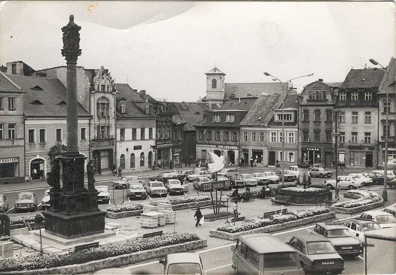 náměstí, tentokrát začátek 80 let. Koloběh života je úžasný a snímek zachycuje několik paralel s dneškem. Morový sloup se rekonstruuje, parkoviště funguje, heslo zbrojením za mír je stále platné, jen na holubici míru se dnes bohužel tak trochu zapomíná. Na chodnících mi tenkrát nescházely předzahrádky a dnešní stromoví bych měl raději na druhé straně vozovky na vnitřním okruhu, ne před domy na chodníku. Ale každý to má jinak a tak to má být, nenechme si vzít vlastní názory a nezatracujme jiné za ty jejich. (archiv Českolipské obrázky)
